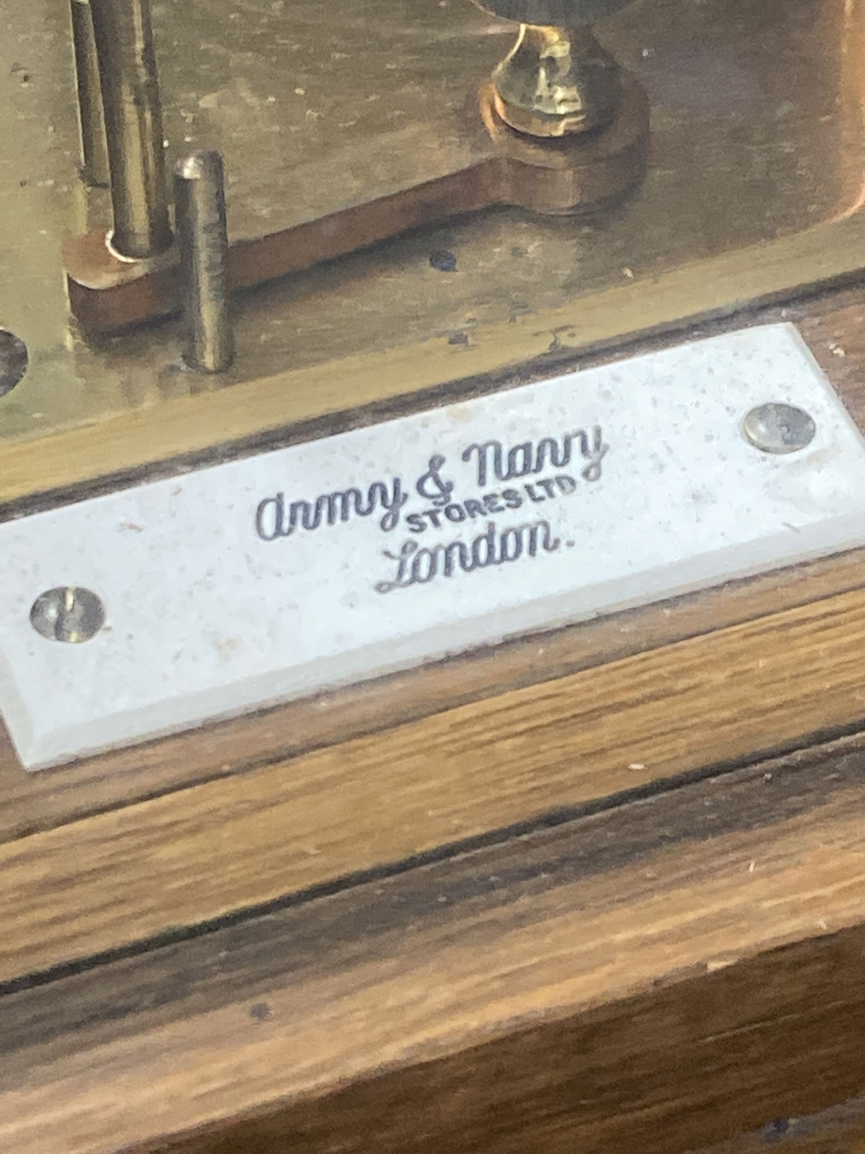 An Edwardian oak barograph retailed by Army & Navy stores ltd. with ink and spare sheets.